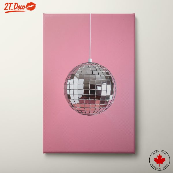 Vibrant Disco Ball Hanging Against Pink Background