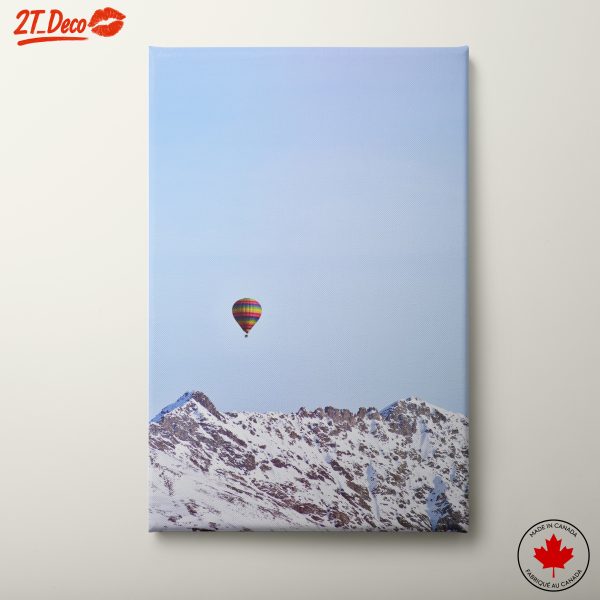 Hot Air Balloon Over Snow-Capped Mountains